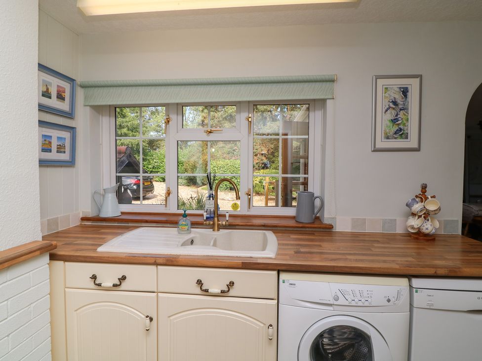 A kitchen with a sink and appliances at Larkspur Cottage in Alford