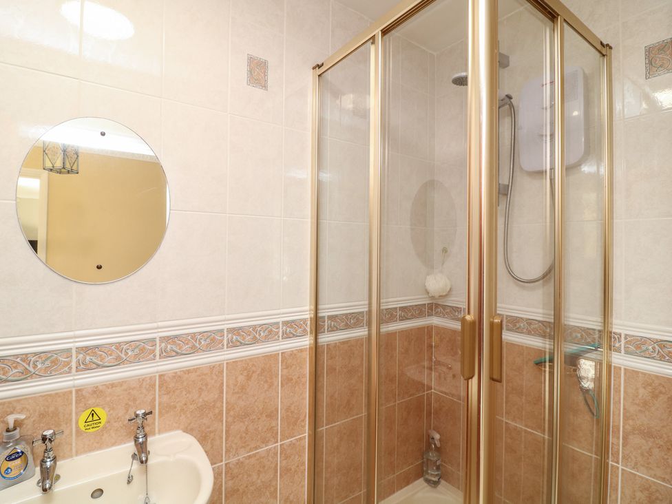 A bathroom with a shower and sink at Larkspur Cottage in Alford