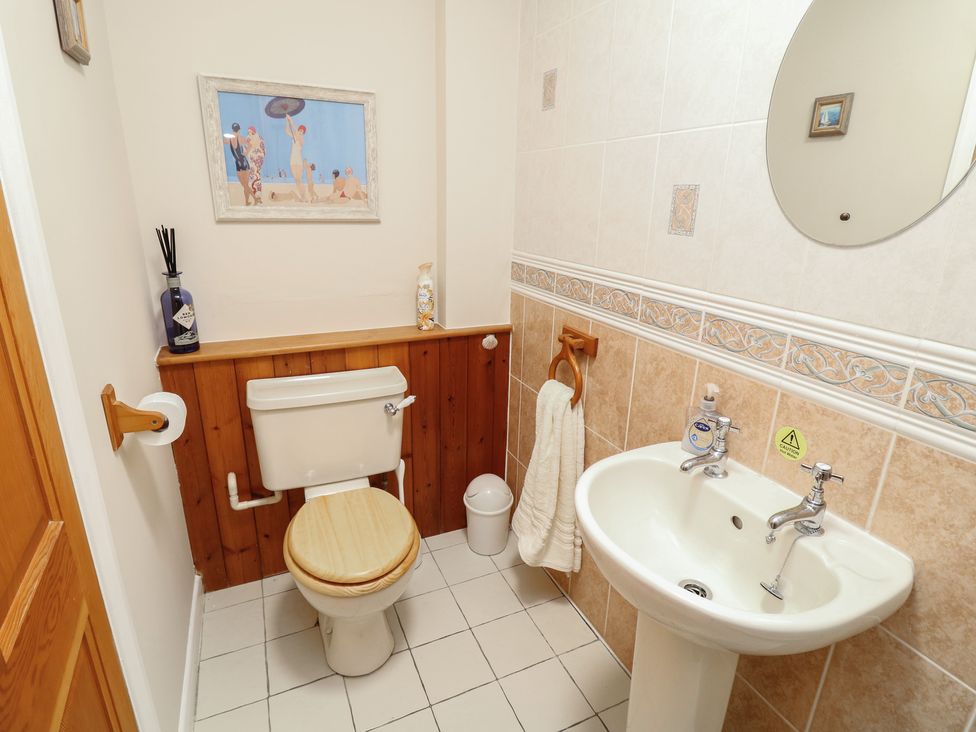A bathroom with a toilet and sink at Larkspur Cottage in Alford