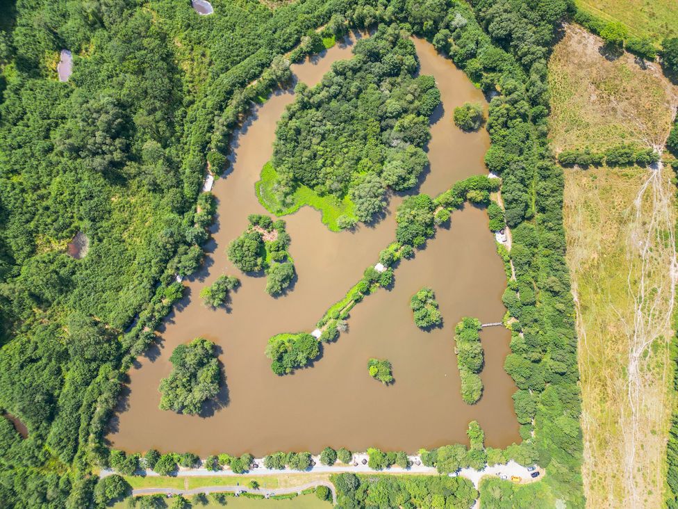 An aerial view of a water body surrounded by trees and greenery at Silver Birch in Dolton