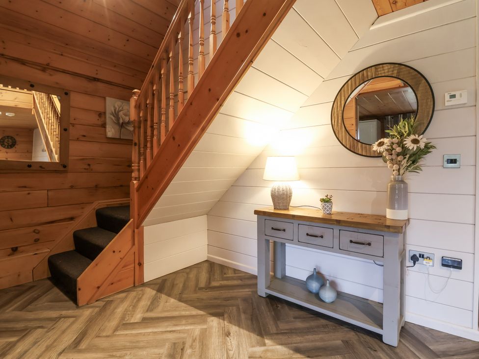 An entrance area with a staircase and a console table at Willow in Dolton