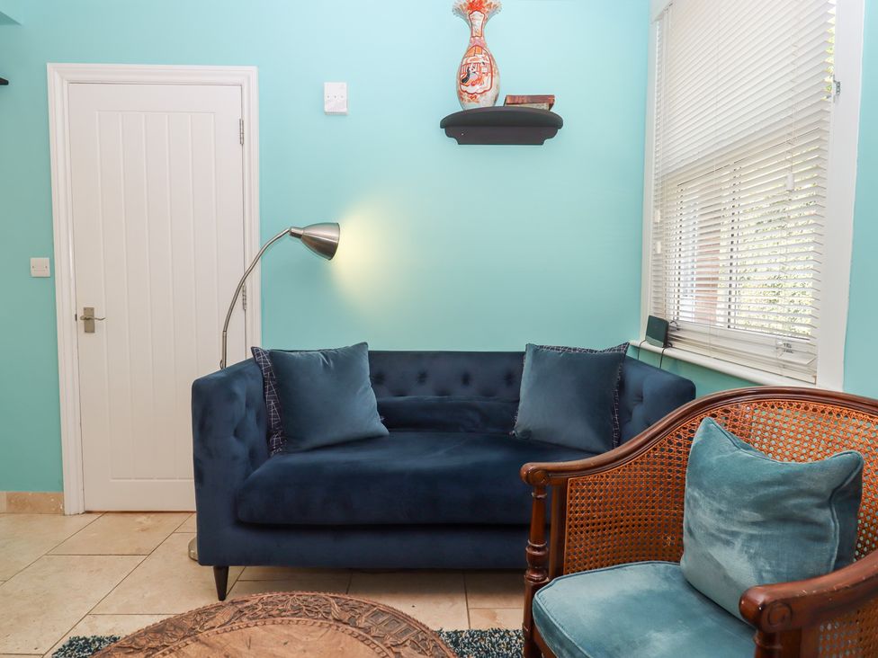 A living room with a sofa and armchair at 5 Exe Street Topsham
