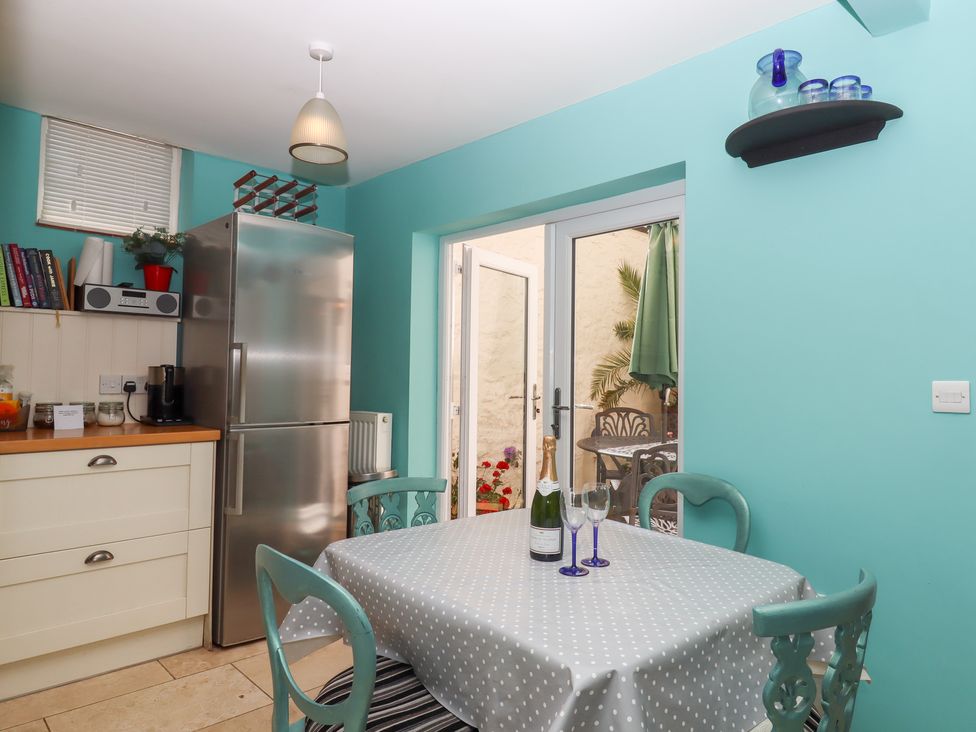 A kitchen with a table and chairs at 5 Exe Street Topsham