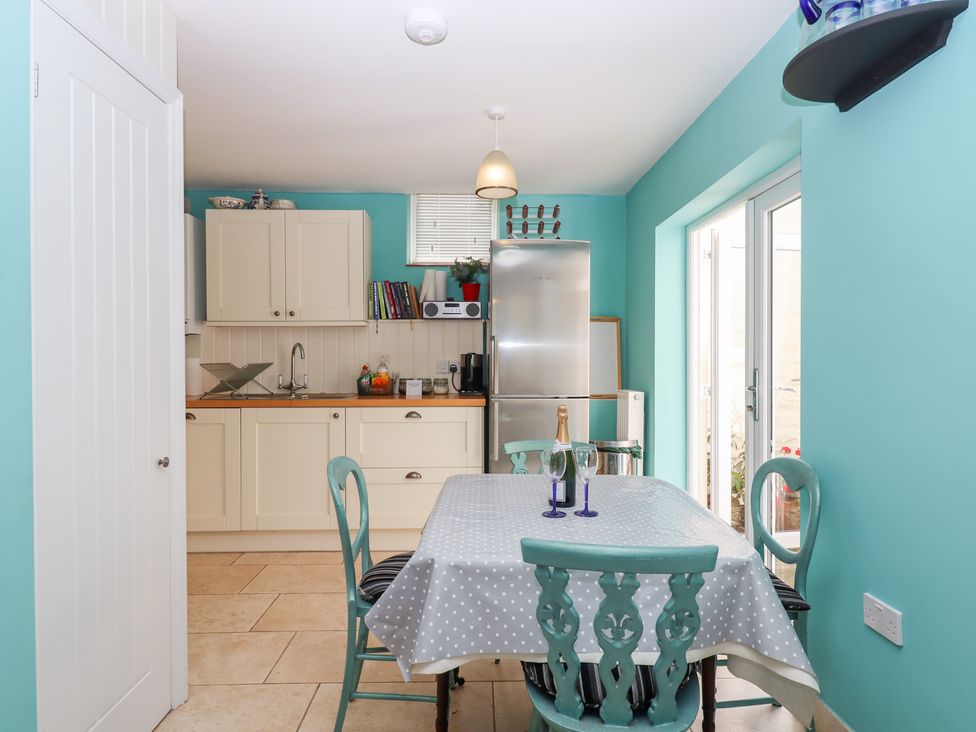 A kitchen with a table and chairs at 5 Exe Street in Topsham