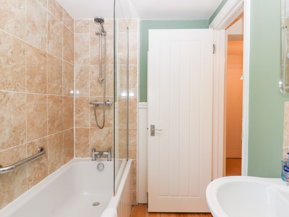 A bathroom with a bathtub and shower at 5 Exe Street Topsham