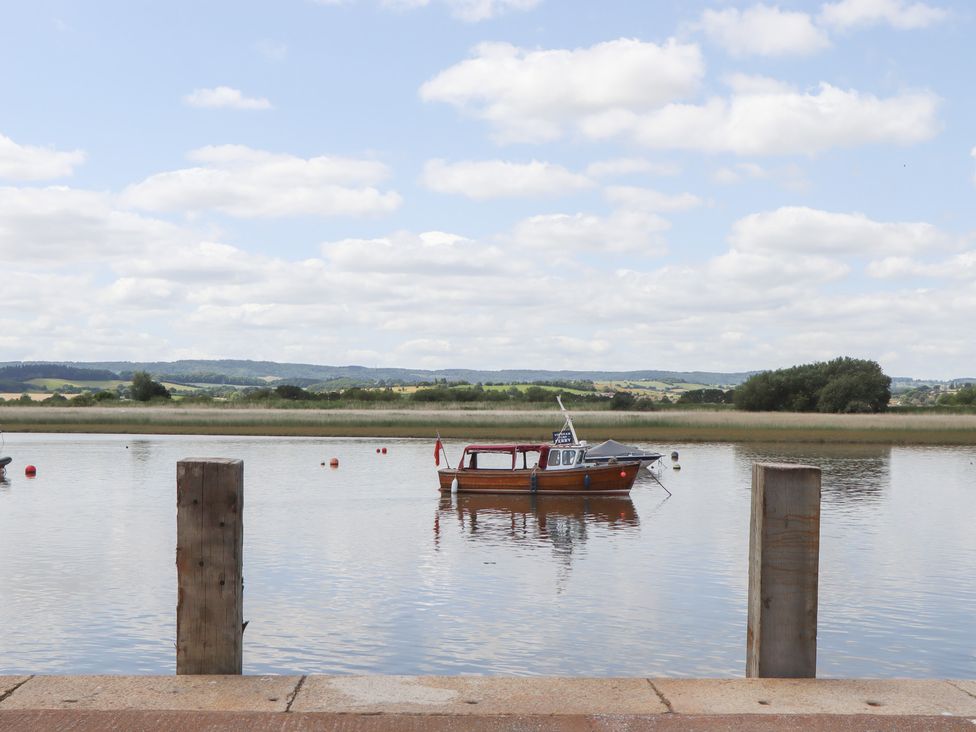 A boat on water with poles in the foreground at 5 Exe Street Topsham