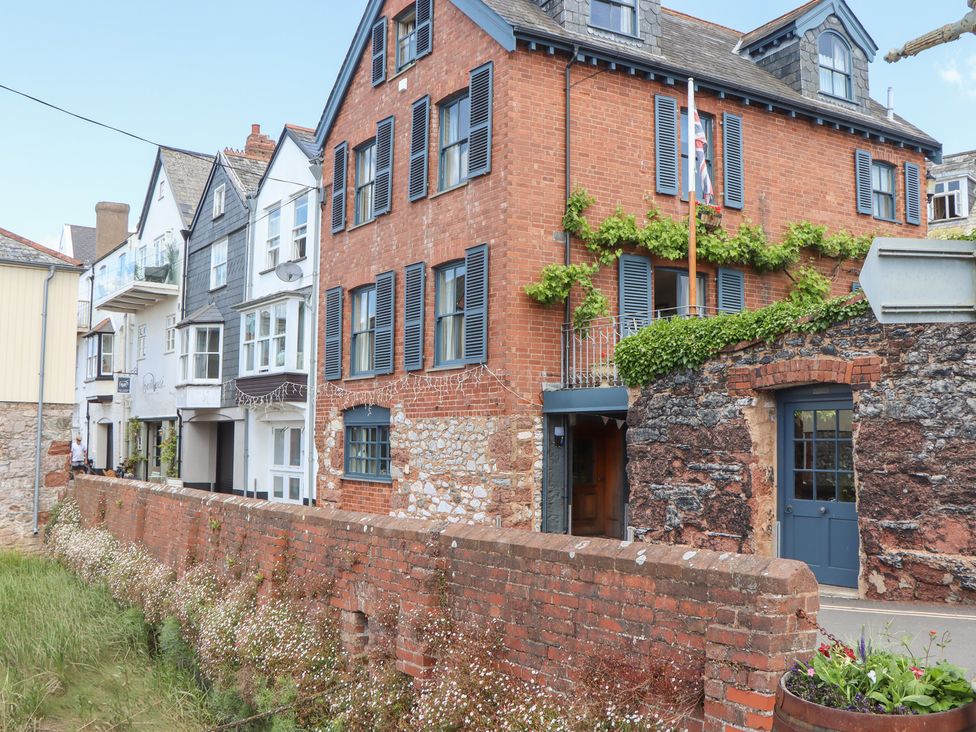 A multi-story building with brick walls and windows at 5 Exe Street Topsham