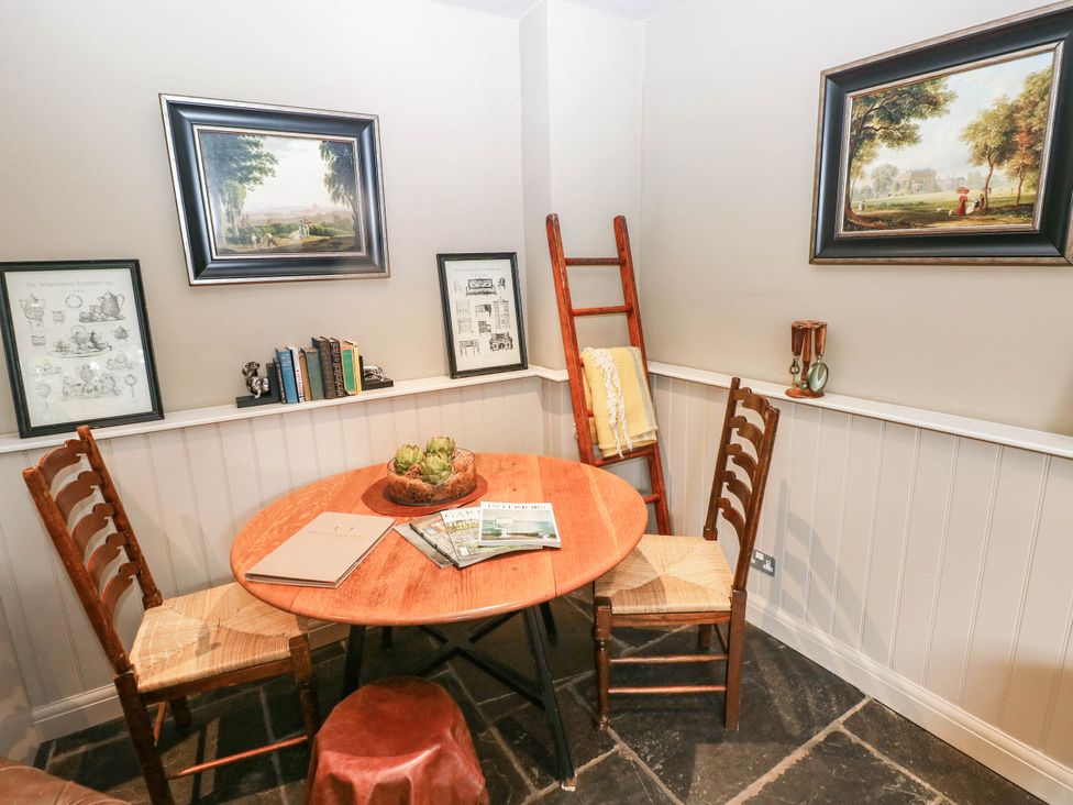 A dining room with a table and chairs at The Stalls at Gileston Manor St Athan