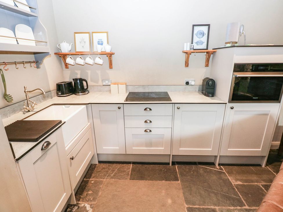 A kitchen with a sink and counter space at The Stalls at Gileston Manor St Athan