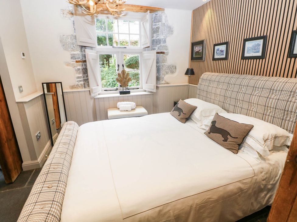 A bedroom with a bed and window at The Stalls at Gileston Manor St Athan