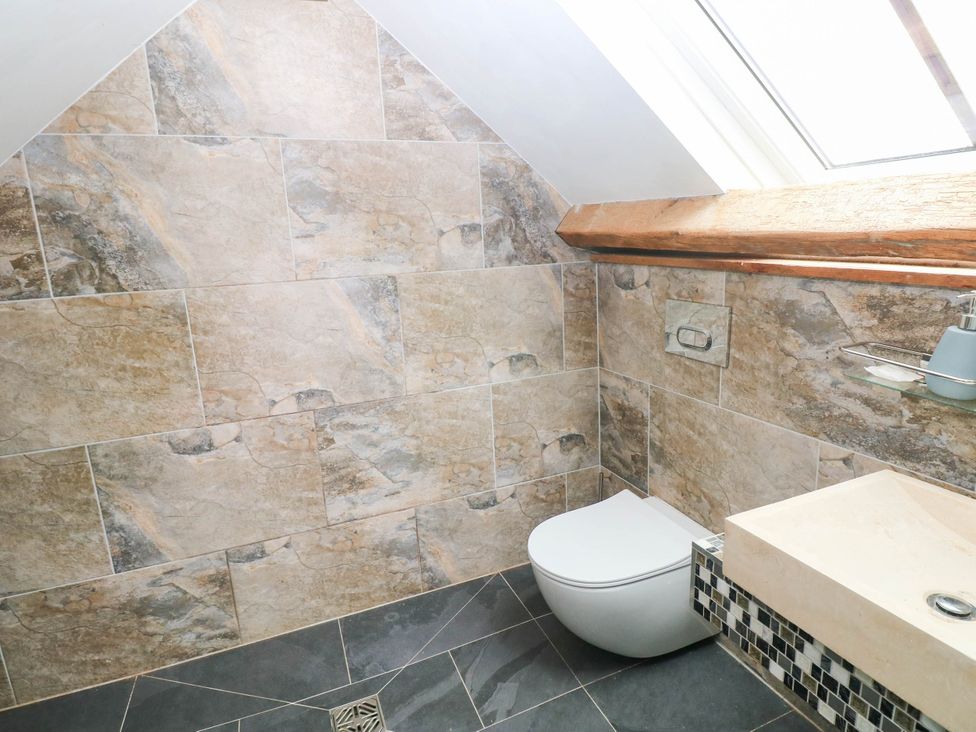 A bathroom with a toilet and sink at The Coach House at Gileston Manor near St Athan