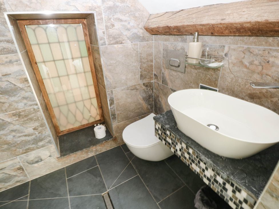 A bathroom with shower, sink, and toilet at The Coach House at Gileston Manor near St Athan