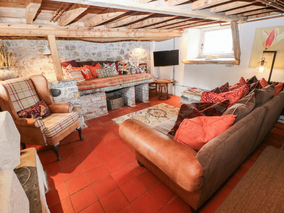 A snug with a sofa and armchair at The Cheese House at Gileston Manor near St Athan