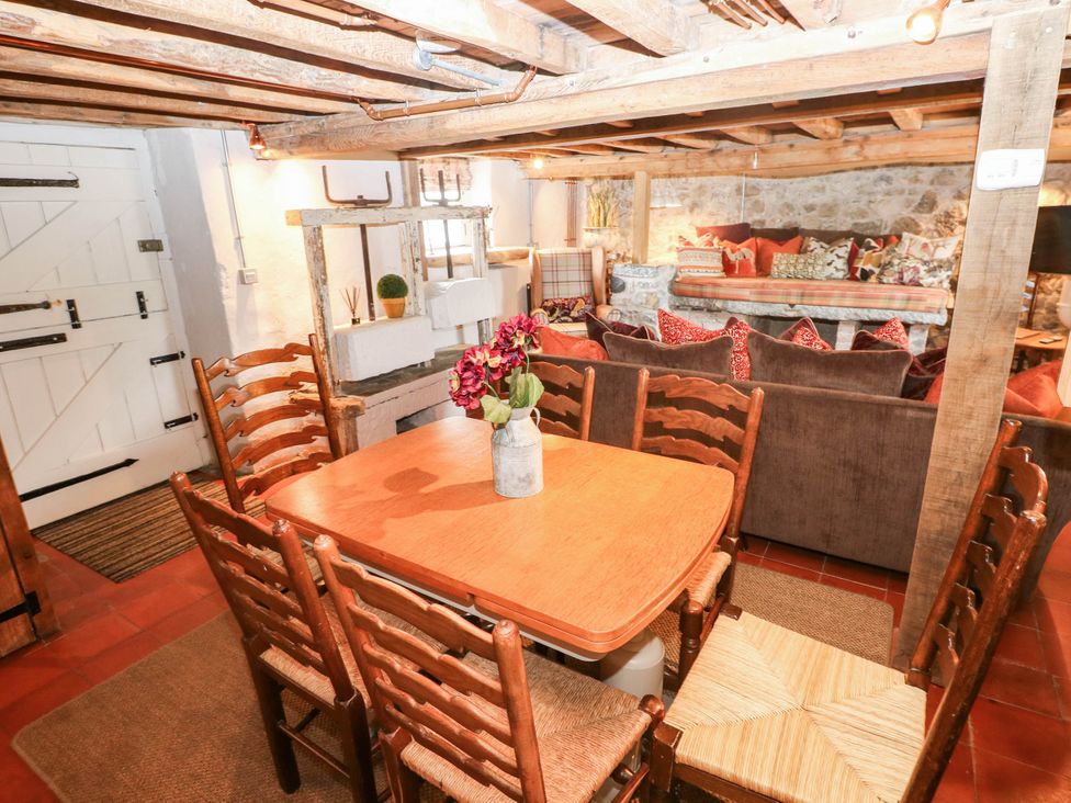 A dining room with a table and chairs at The Cheese House at Gileston Manor near St Athan