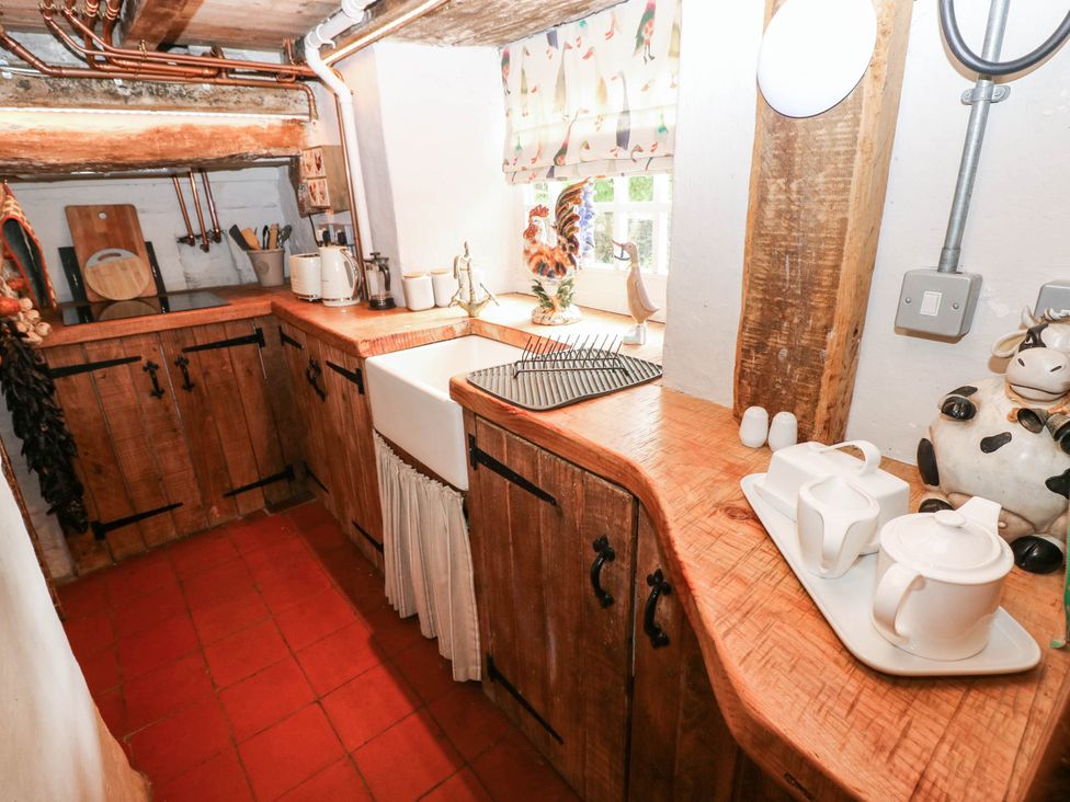 A kitchen featuring a wooden countertop and sink at The Cheese House at Gileston Manor near St Athan