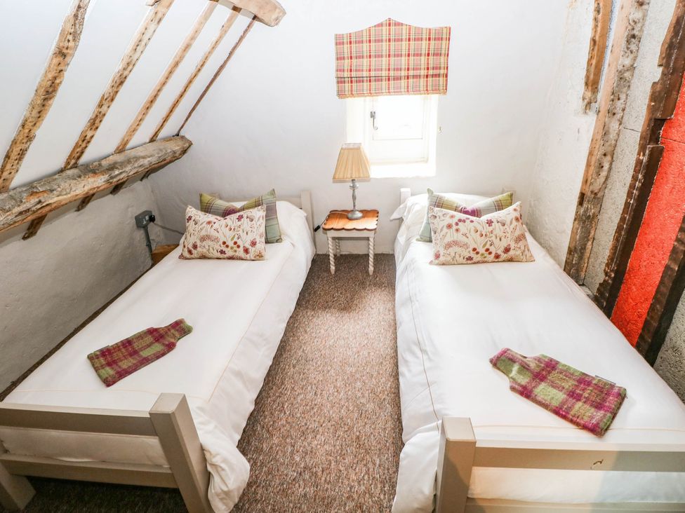 A bedroom with two single beds with pillows at The Cheese House at Gileston Manor near St Athan