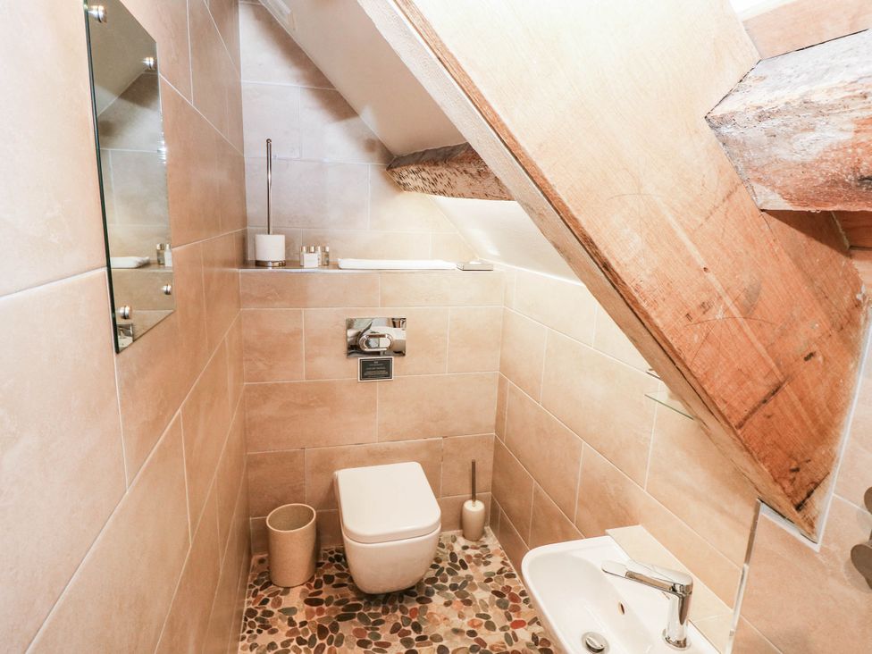A bathroom with a toilet and sink at The Cheese House at Gileston Manor near St Athan