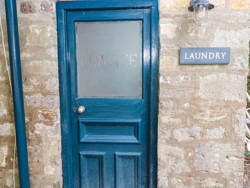 A blue door with a private sign and a laundry sign at The Stables at Gileston Manor St Athan
