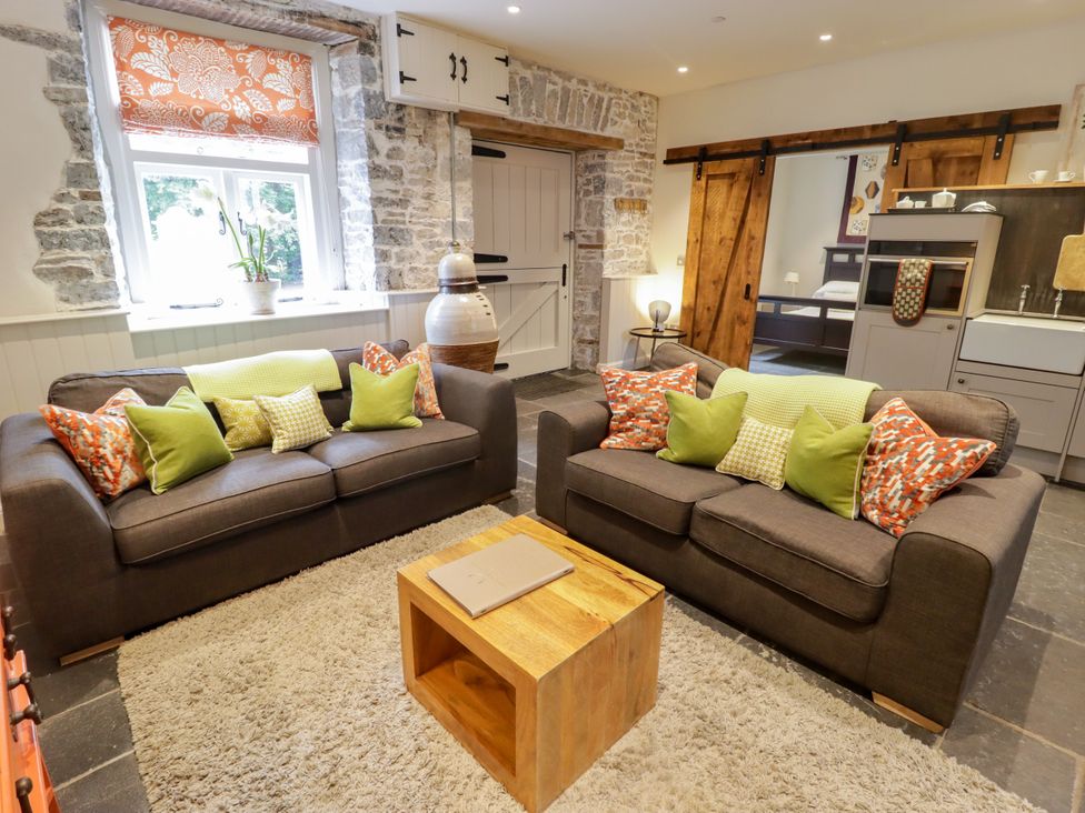 A living room with sofas and a coffee table at The Stables at Gileston Manor St Athan