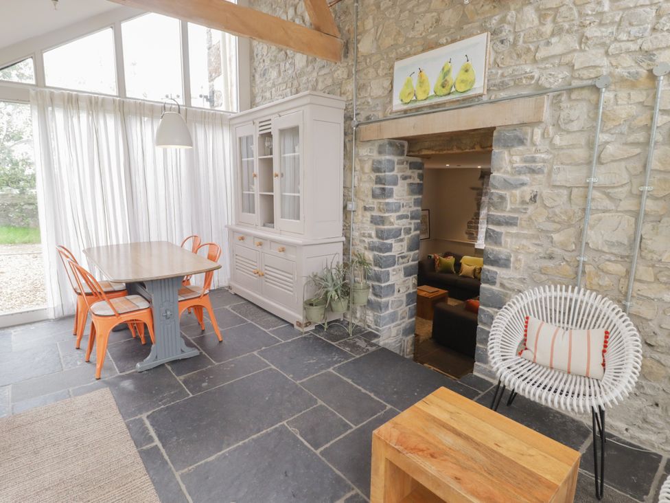 A dining room with a table and chairs at The Stables at Gileston Manor St Athan