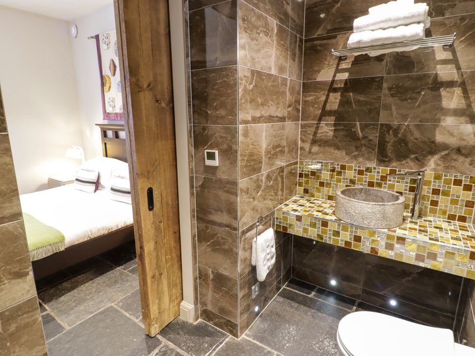 A bathroom with sink and toilet at The Stables at Gileston Manor St Athan