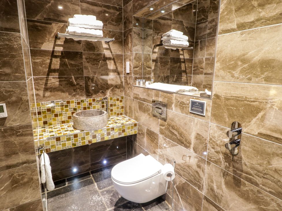 A bathroom with a sink and toilet at The Stables at Gileston Manor St Athan