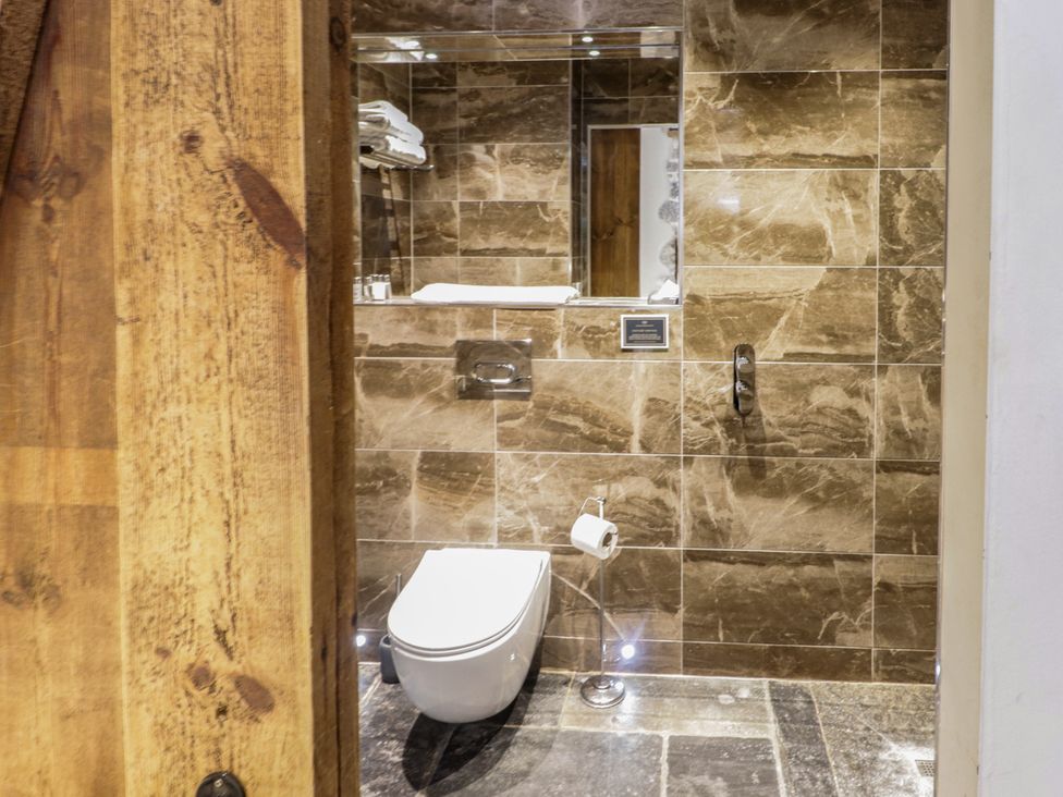 A bathroom with a toilet and sink at The Stables at Gileston Manor, St Athan
