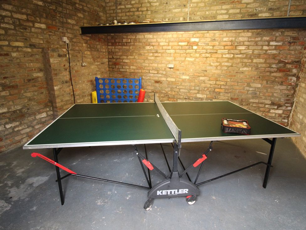A ping pong table and connect four game in a storage area at The Old Post Office Shipton By Beningbrough near York