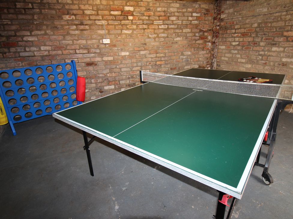 A games room with a ping pong table and a Connect Four game at The Old Post Office Shipton By Beningbrough near York