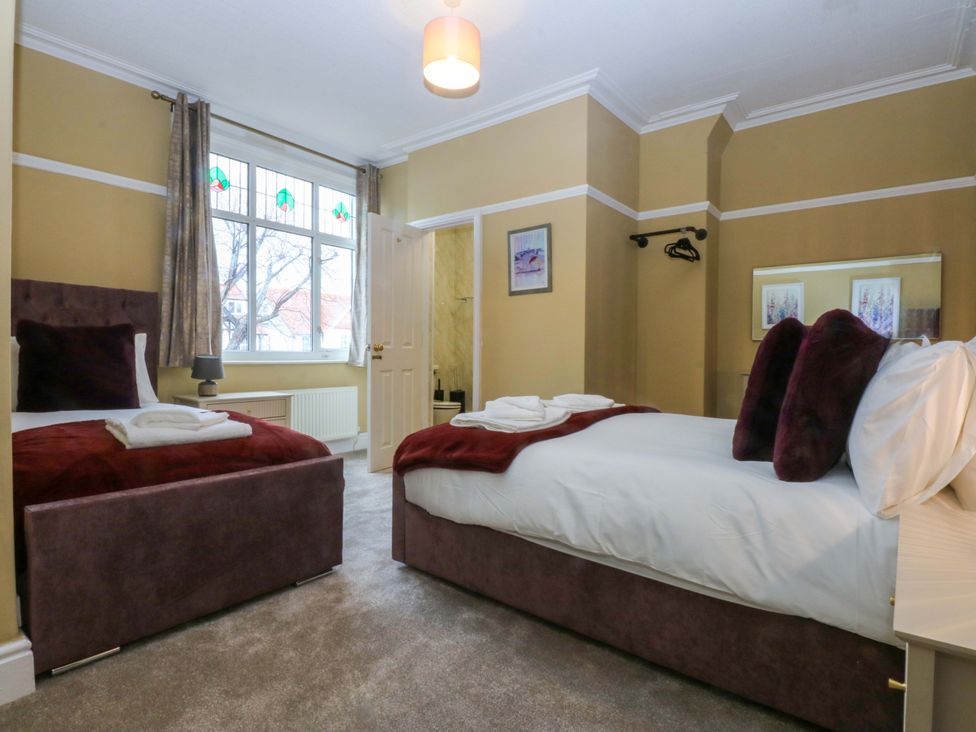 A bedroom with two beds and a window at Southbourne Manor in Llandudno