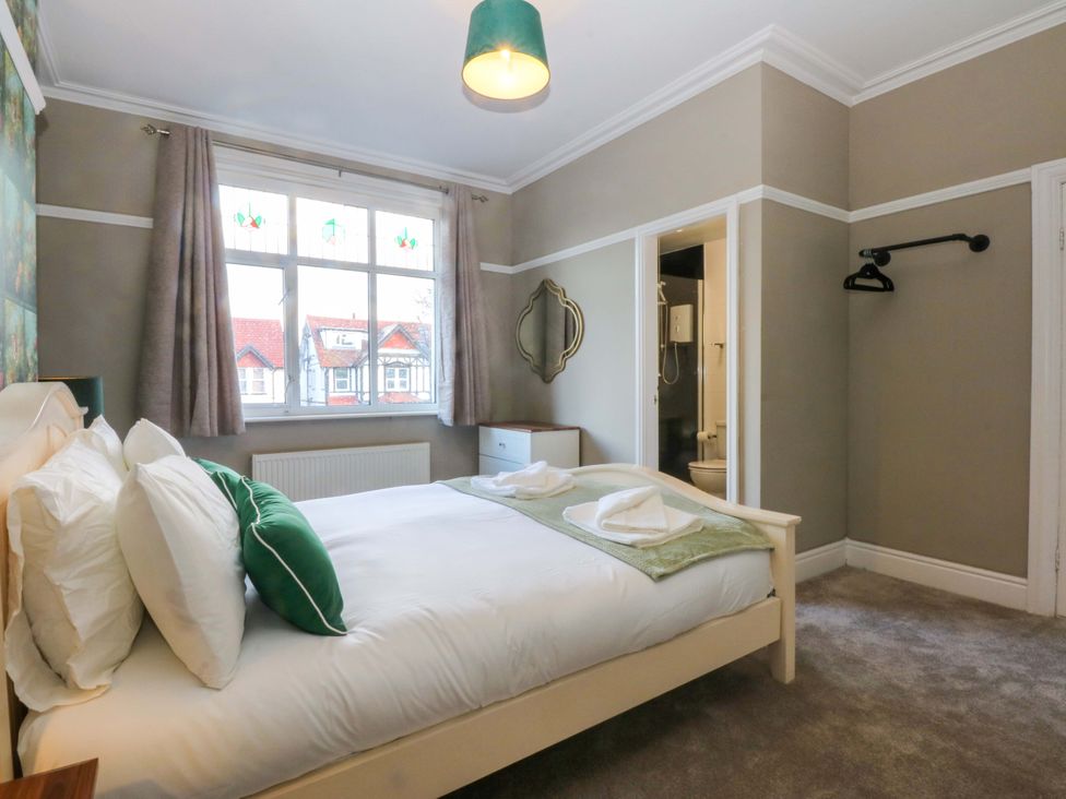 A bedroom with a bed and a window at Southbourne Manor in Llandudno