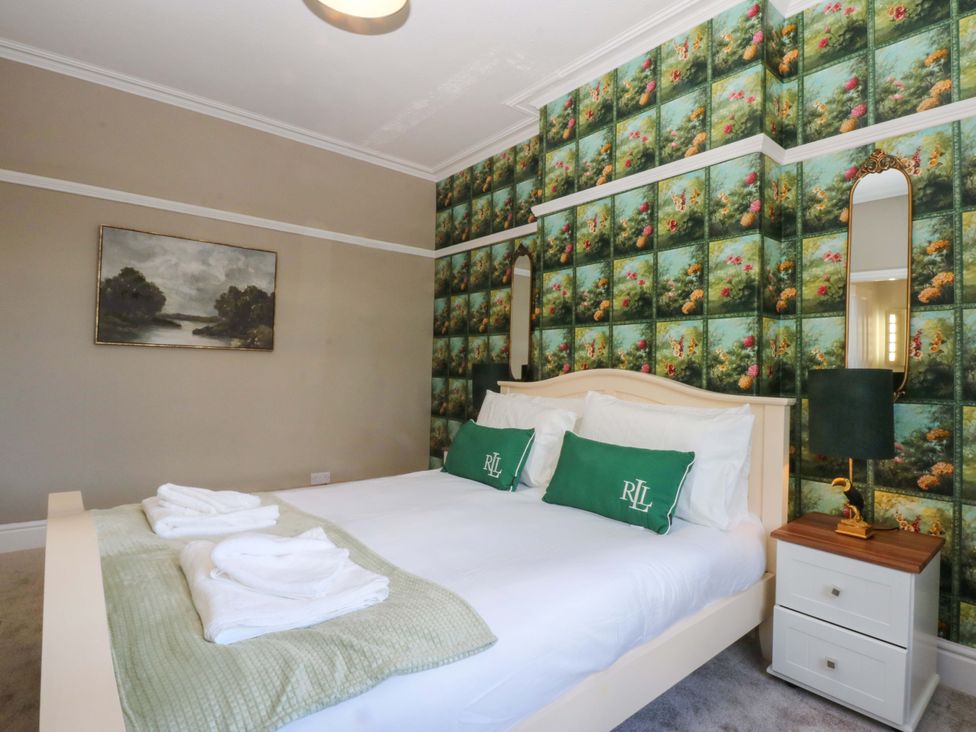 A bedroom with a bed and bedside table at Southbourne Manor in Llandudno