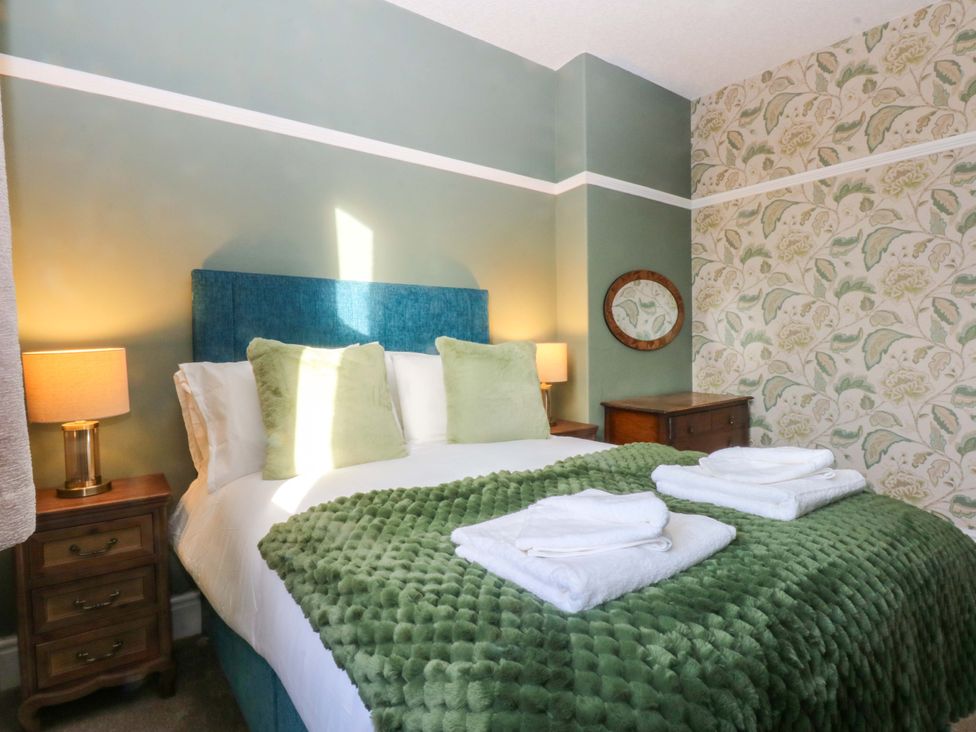 A bedroom with a bed and bedside tables at Southbourne Manor in Llandudno