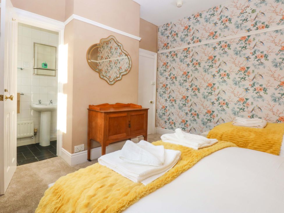 A bedroom with a bed and a dresser at Southbourne Manor in Llandudno