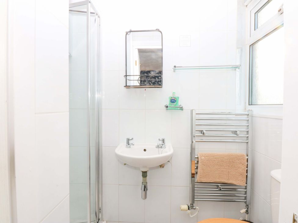 A bathroom with a shower, sink, and toilet at Southbourne Manor in Llandudno