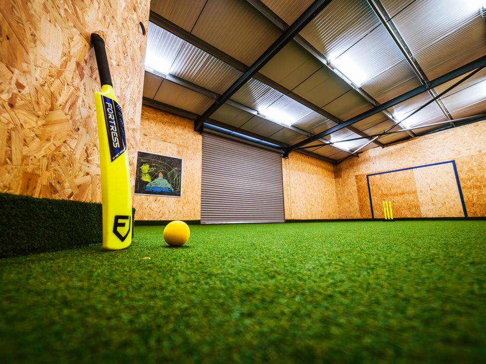 A sports training facility with a cricket bat, ball, and goal posts at Glanllyn Bach, Llanfaelog