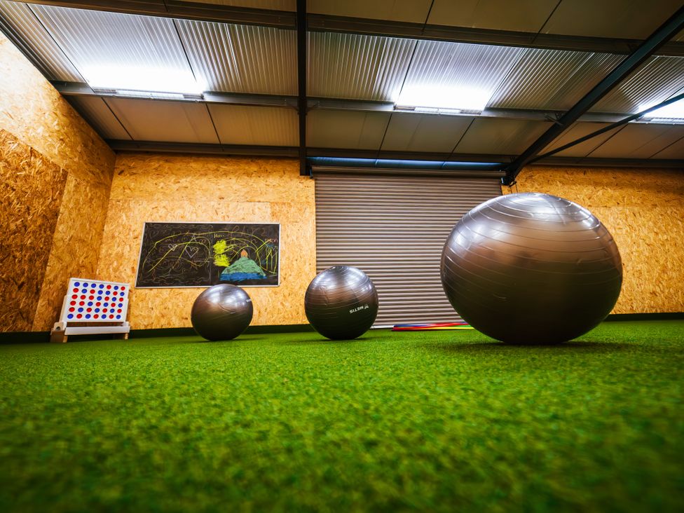 A room with exercise balls and a board game at Glanllyn Bach Llanfaelog