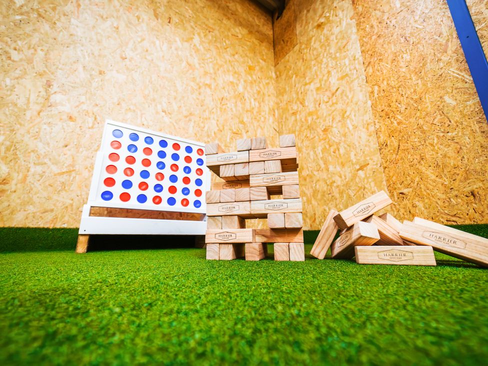 A game area with Connect Four and wooden blocks at Glanllyn Bach in Llanfaelog