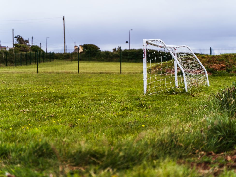 A goal post on a grass field at Glanllyn Bach in Llanfaelog