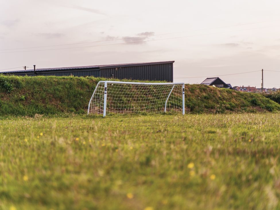 A soccer goalpost on a grassy field at Glanllyn Bach in Llanfaelog