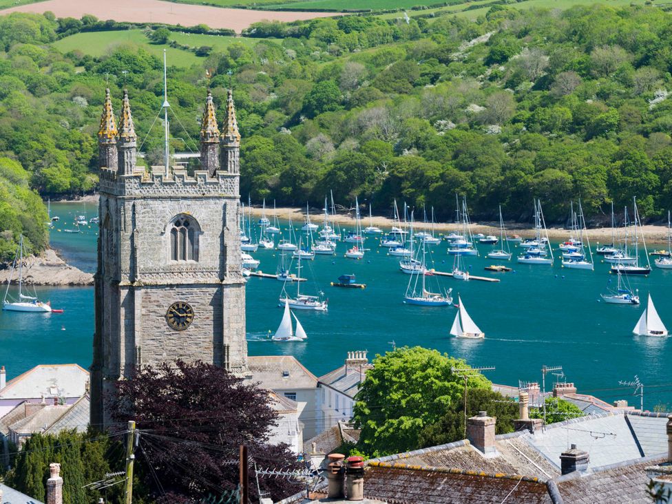 A church tower overlooking boats in the water at 10 Stonerush Valley Lanreath near Looe