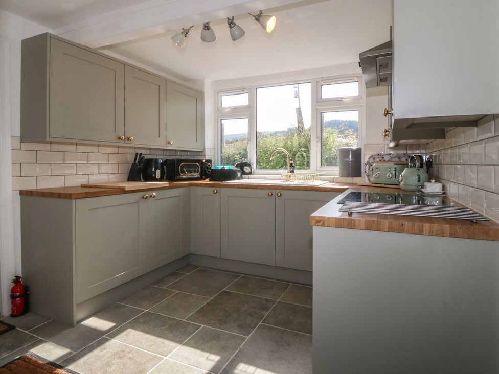 A kitchen with cabinetry and appliances at Tan Y Merddyn in Ceunant near Llanrug
