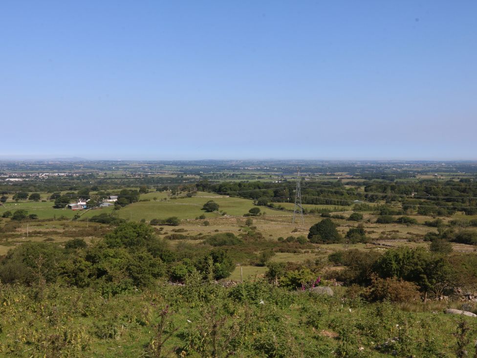 A landscape view with fields and trees near Ceunant, Tan Y Merddyn