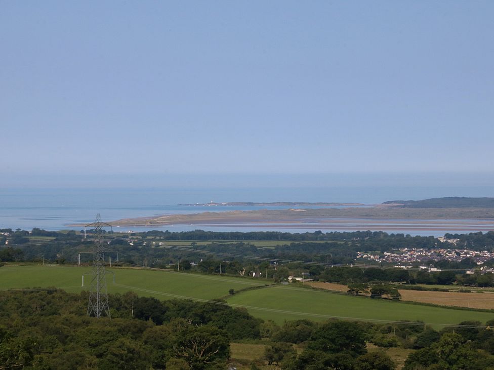 A coastal landscape with water and fields at Tan Y Merddyn Ceunant near Llanrug