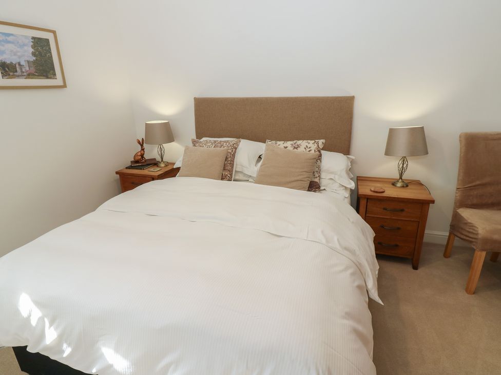 A bedroom with a bed and nightstands at Parr Cottage Snape near Bedale
