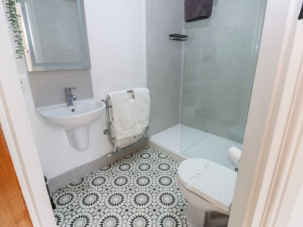 A bathroom with a shower, sink and toilet at Parr Cottage Snape near Bedale