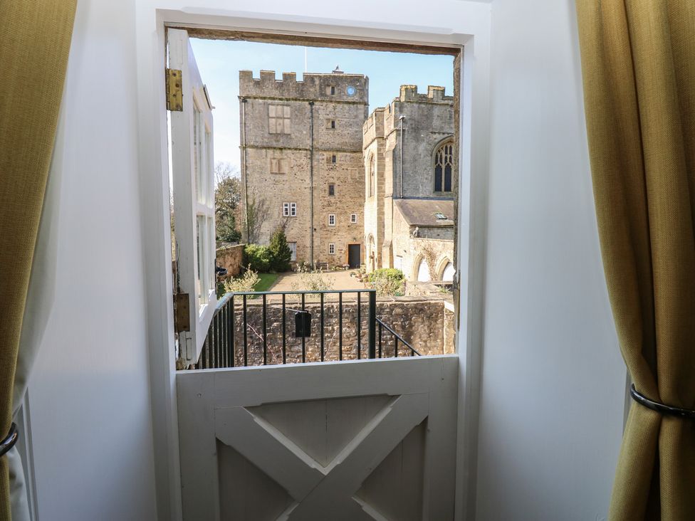 A view from a window showing a castle and garden at Parr Cottage in Snape near Bedale