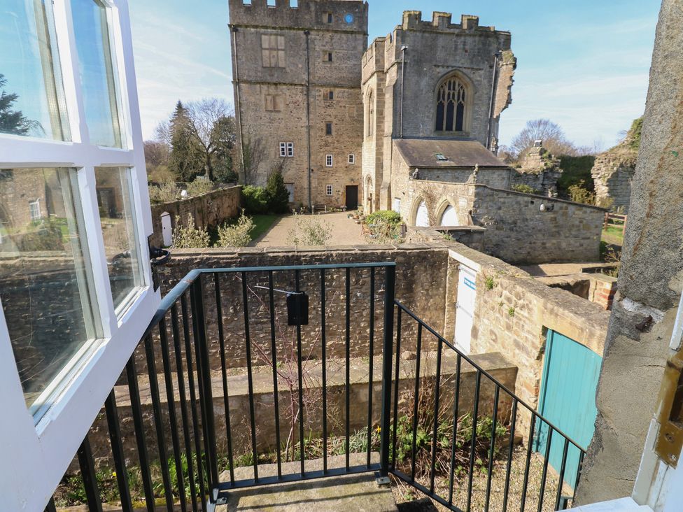 An outdoor area with a view of a stone building at Parr Cottage in Snape near Bedale