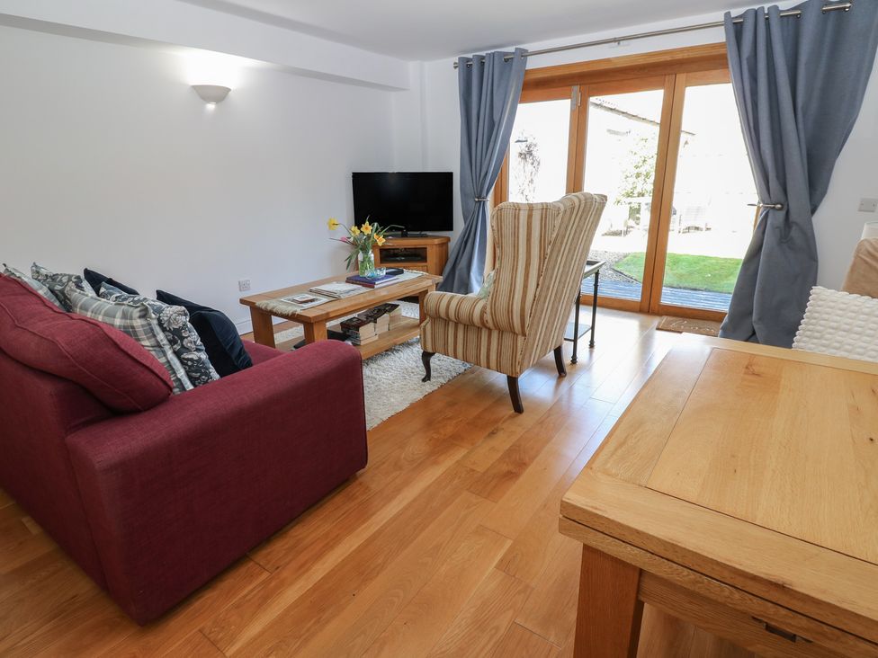 A living room with furniture and a television at The Cart House in Snape near Bedale