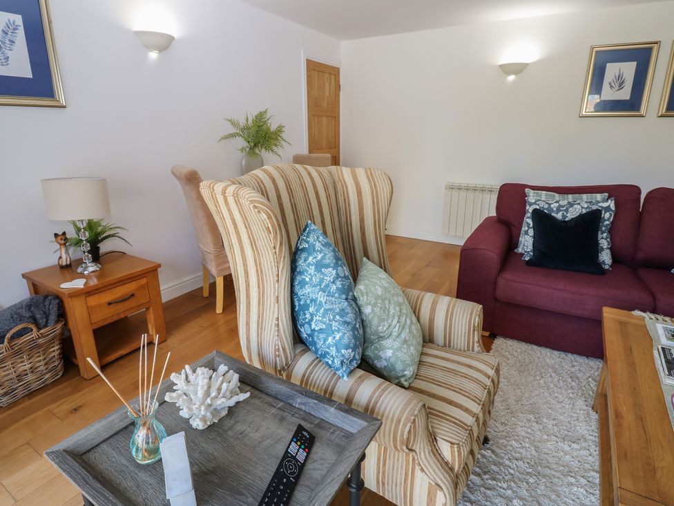 A living room with an armchair and sofa at The Cart House in Snape near Bedale